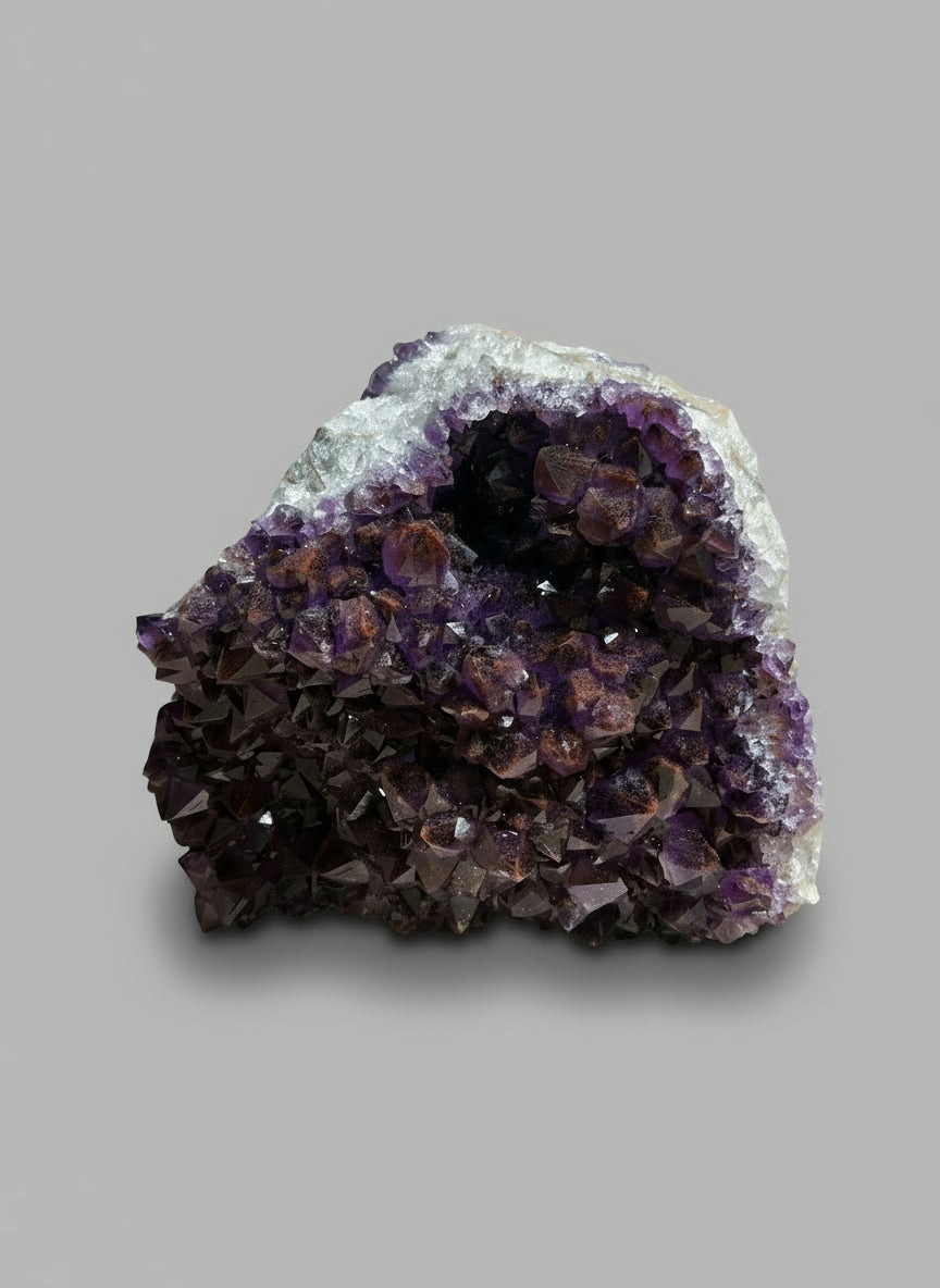 Amethyst crystal cluster on a wooden surface