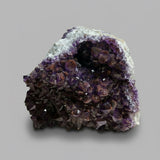 Amethyst crystal cluster on a wooden surface