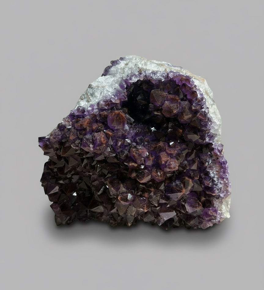 Amethyst crystal cluster on a wooden surface